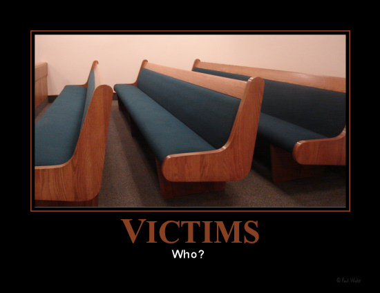Picture of empty benches in a courtroom.