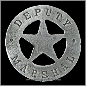 Deputy Marshall Wild West Law Enforcement Badges. These replica badges are cast from a tin and zinc alloy, using molds made from the original, authentic badge, and has a pin soldered on the back. Special care and attention has been given to retaining every minute detail of the original badge. Copyright Milne Jewelry Company.